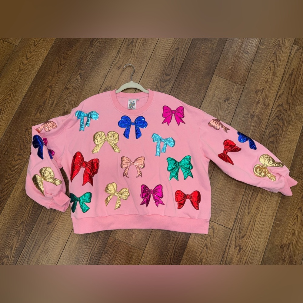 Women’s Queen of Sparkles Pink & Multi Bow sweatshirt.